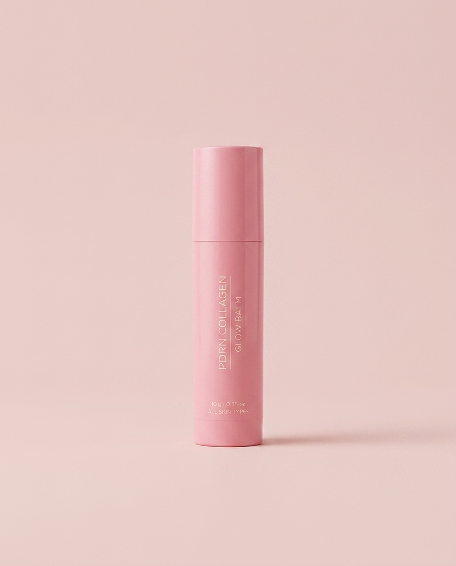 PDRN Collagen Glow Balm pink stick on a soft blush pink studio background