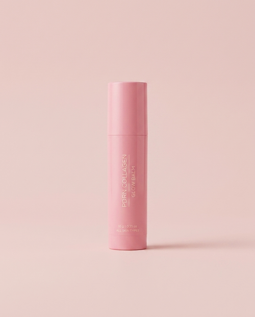 PDRN Collagen Glow Balm pink stick on a soft blush pink studio background