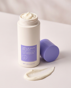 Open jar of Tighten and Smooth Belly Cream with rich whipped cream texture swatch