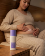 Woman massaging Tighten and Smooth Belly Cream into her stomach in warm evening light